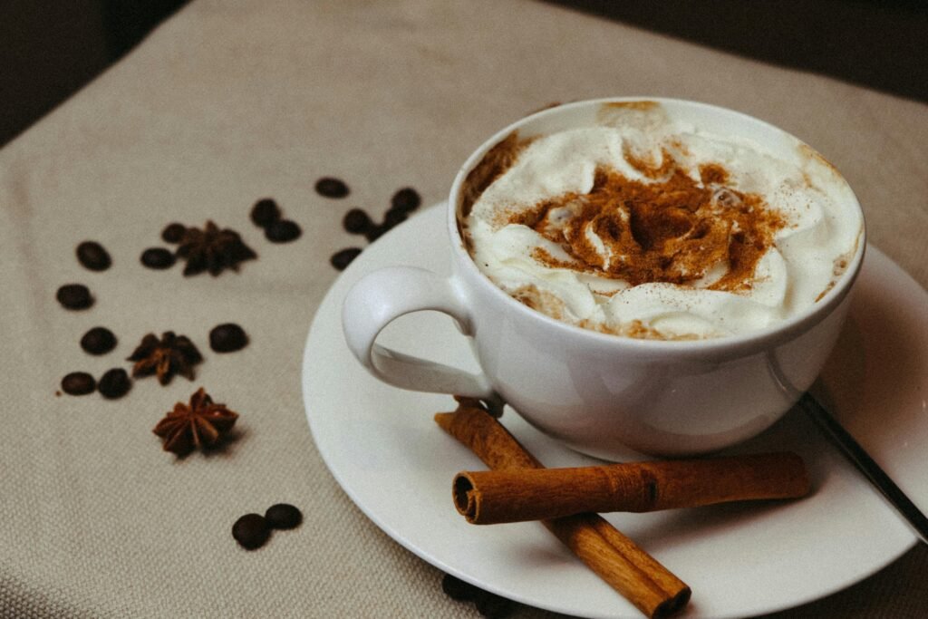 Warm and inviting cappuccino topped with cream and cinnamon, perfect for comfort and taste.