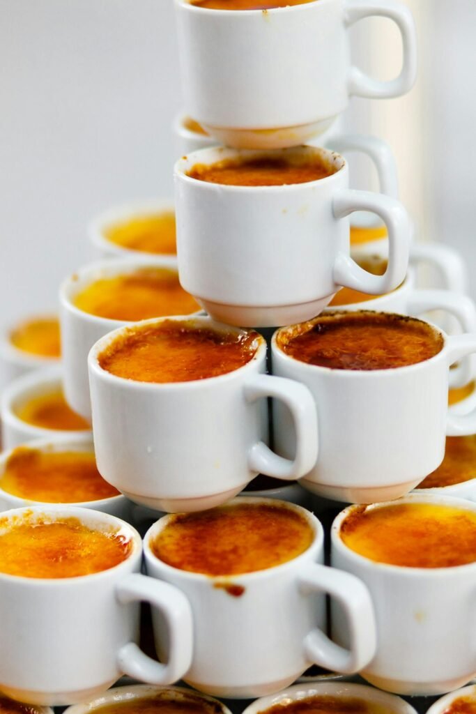 A delicious stack of crème brûlée in white cups, perfect for food photography.