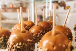 Close-up of caramel apples with nuts on display in San Antonio.